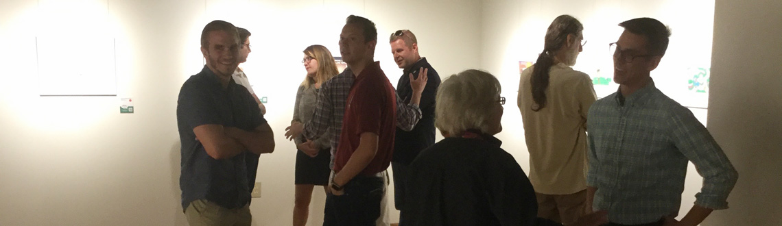 Photo of spectators admiring work in the Oglesby Gallery
