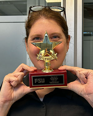 Photo of Katie Redd holding her award