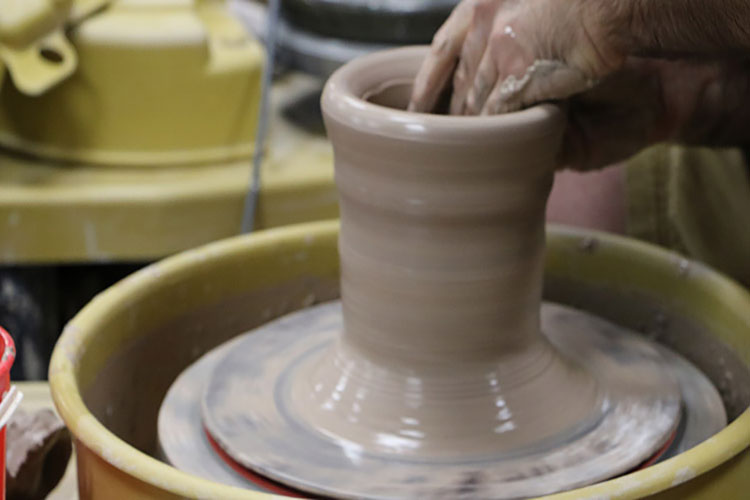 Making pottery on a wheel