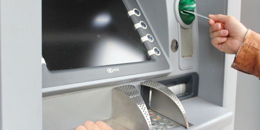 photo of man using atm
