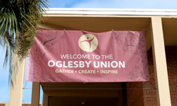 Photo of Oglesby Union banner hanging outside of the Oglesby Union building